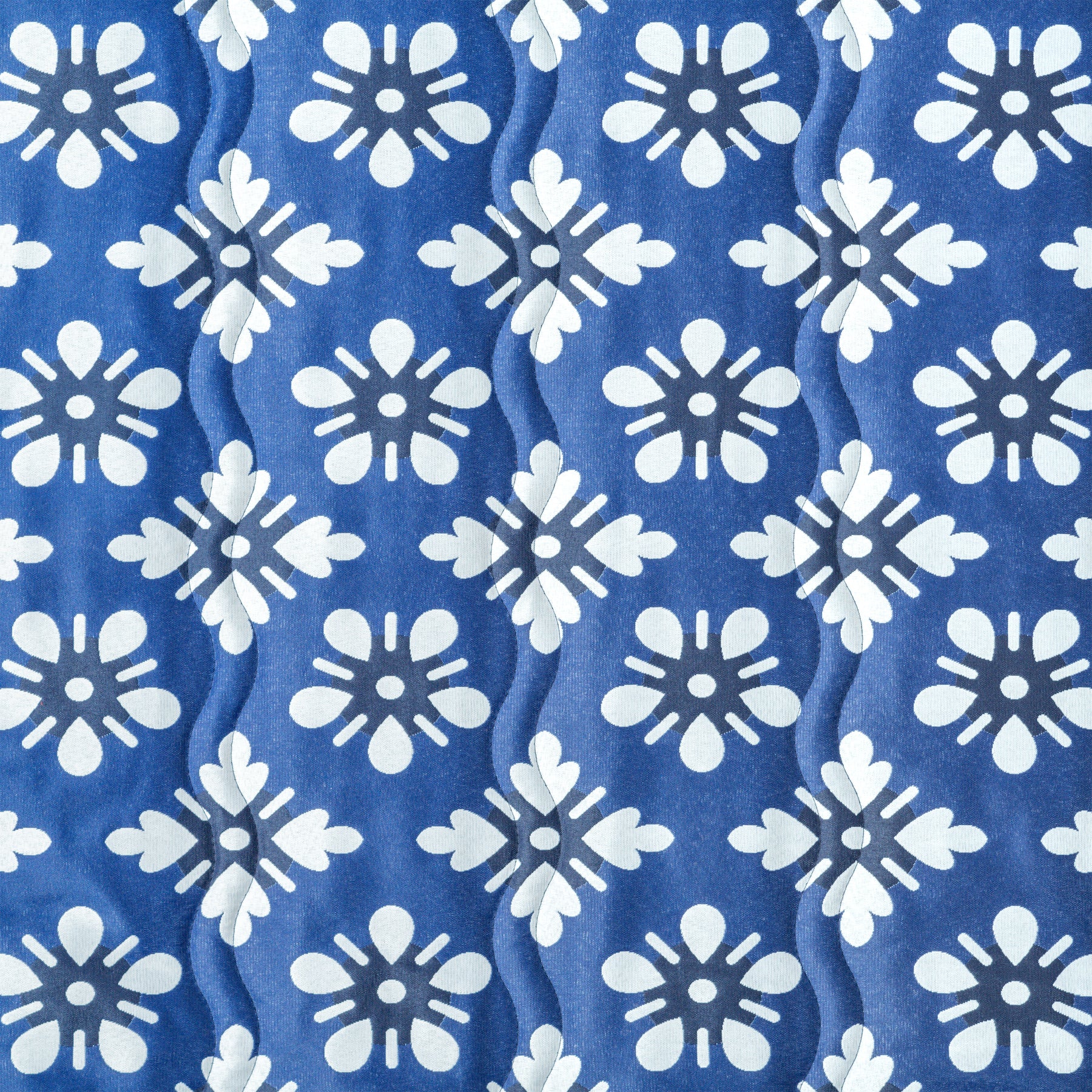 Close up of the fabric and pattern for the Bliss Hammocks 55-inch Wide 2-Person Reversible Quilted Hammock in the blue flowers variation.