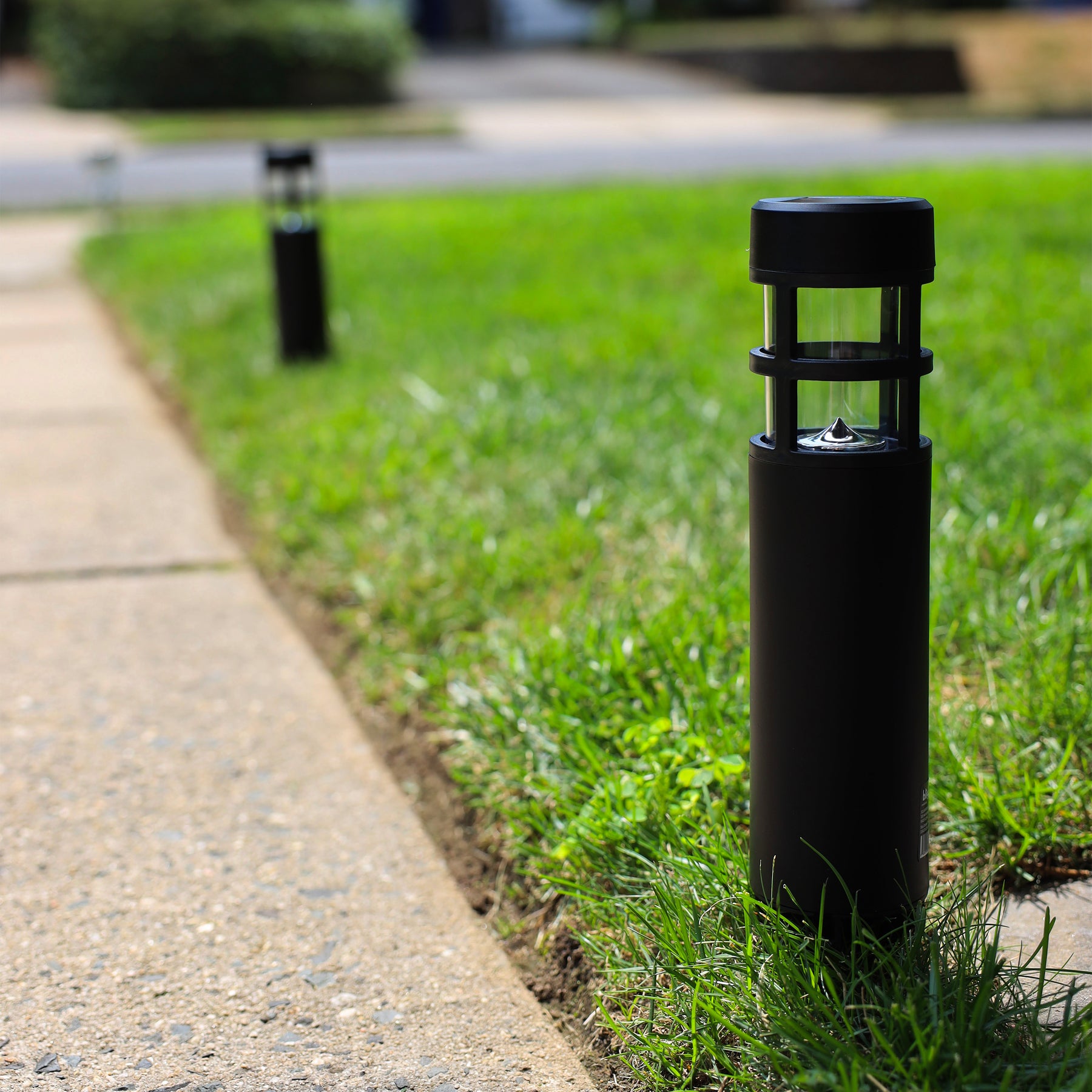Solar LED pathway lights line along the side of a front walkway.