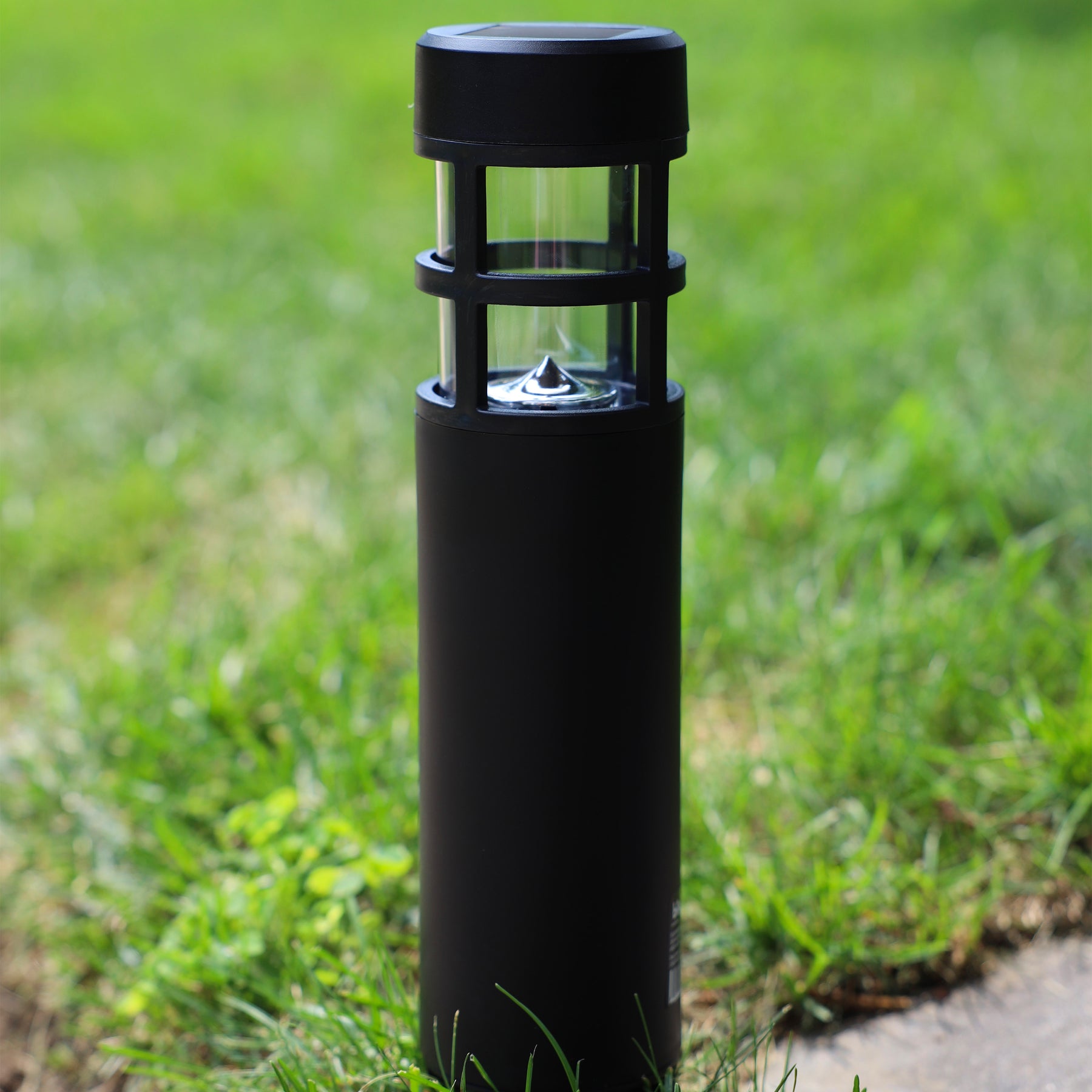 Solar LED light staked into the grass.