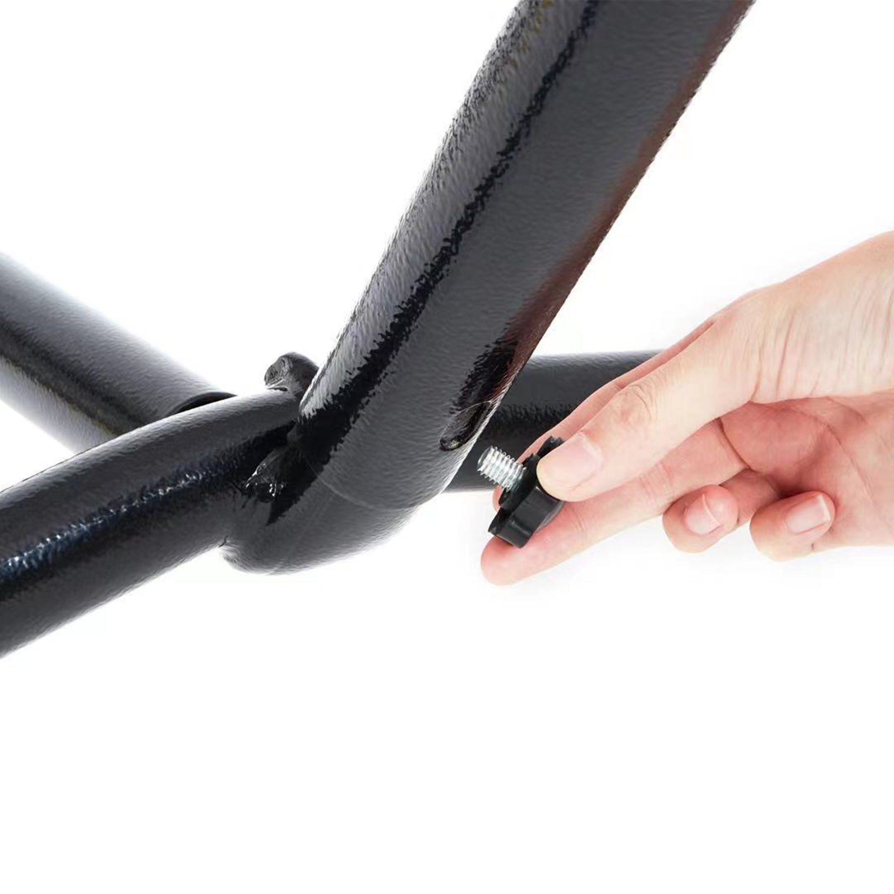 Person putting a screw into the Bliss Hammocks Stand.