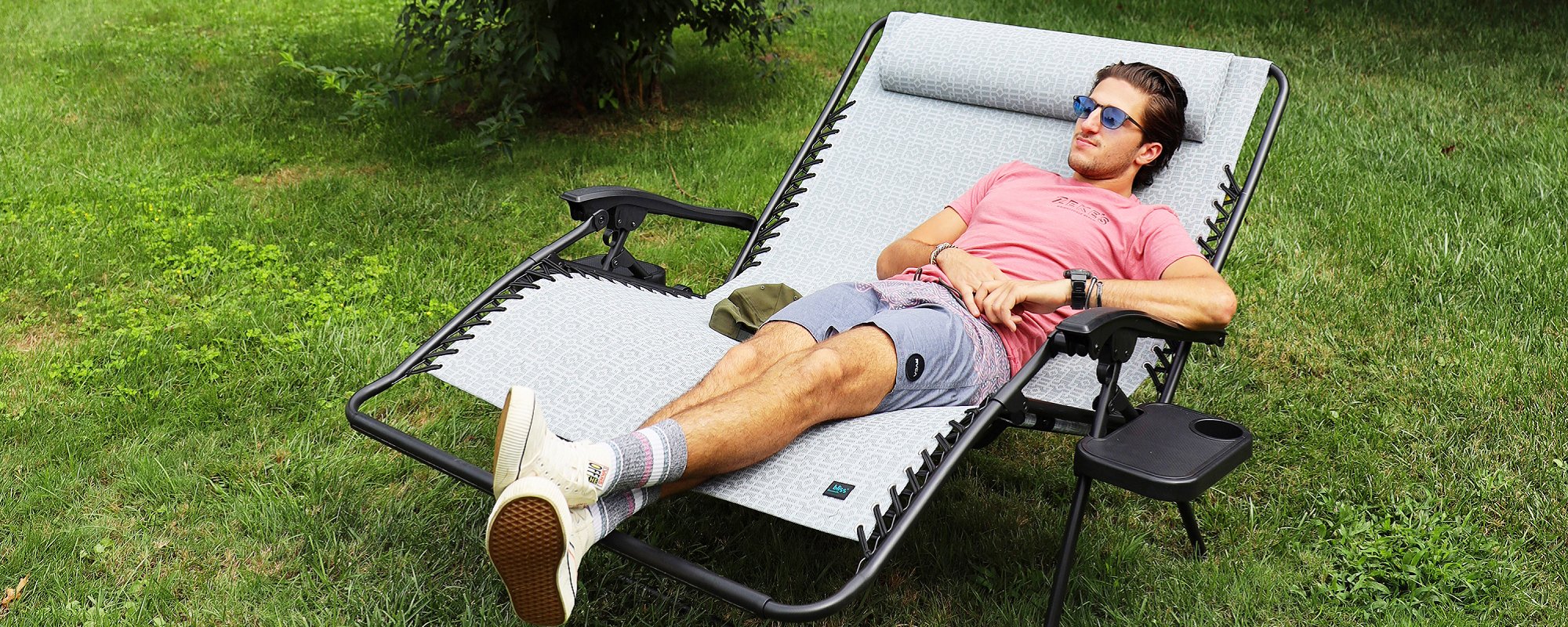 Young man relaxing in a Bliss Hammocks 2-person Gravity Free Chair.
