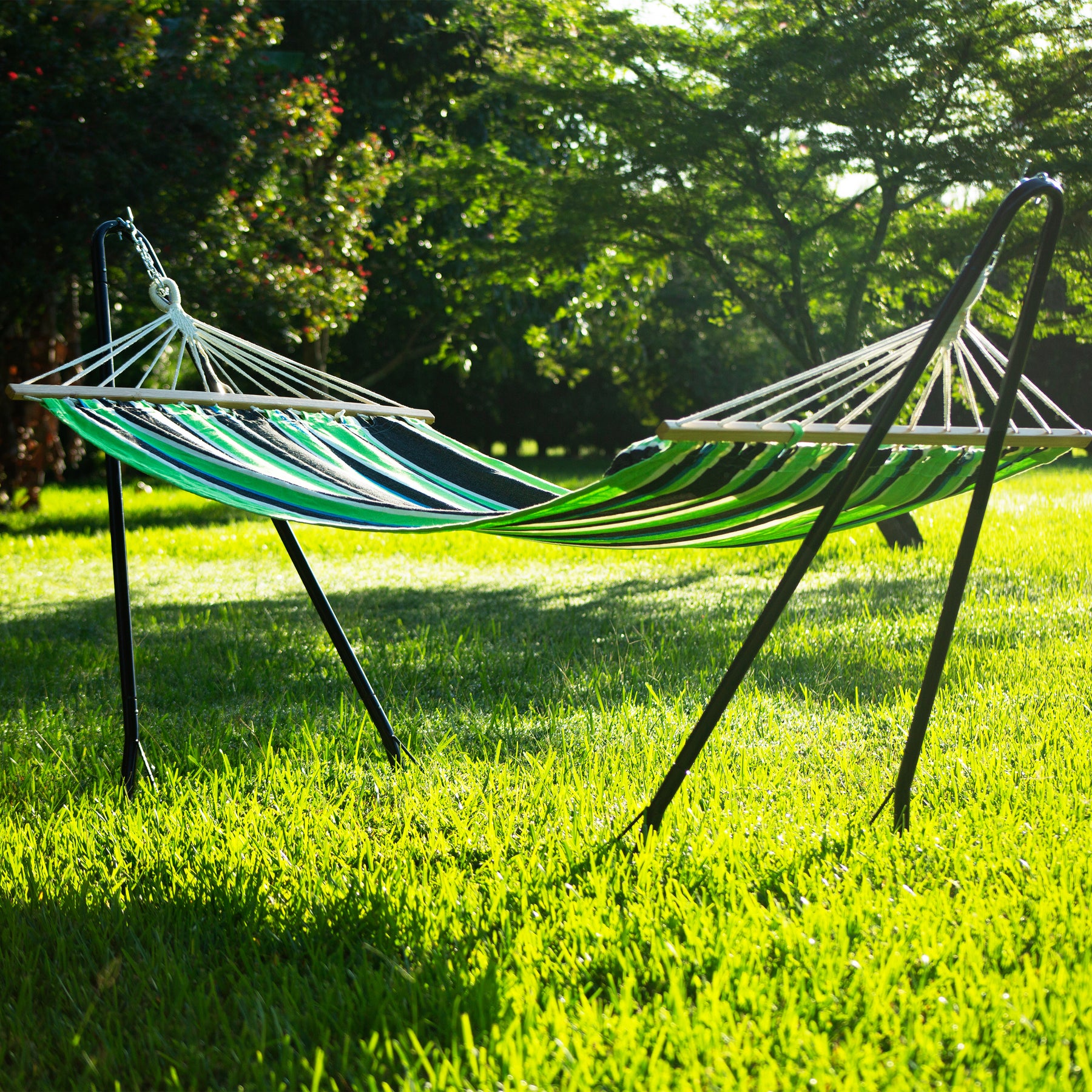 Bliss Hammocks 48-inch Wide Caribbean Hammock with chains attached to a Bliss Hammock Stand in the grass.