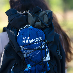 Person carrying the Bliss Hammocks 52-inch Hammock in a Bag strapped to their backpack.