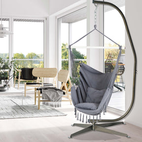 40-inch wide grey hammock chair hanging from a stand in a living room.
