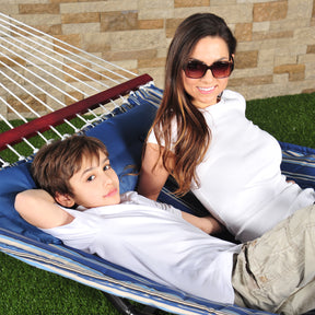 Woman and young boy laying in the Bliss Hammocks 55-inch Wide Quilted Hammock with Spreader Bars and Pillow.