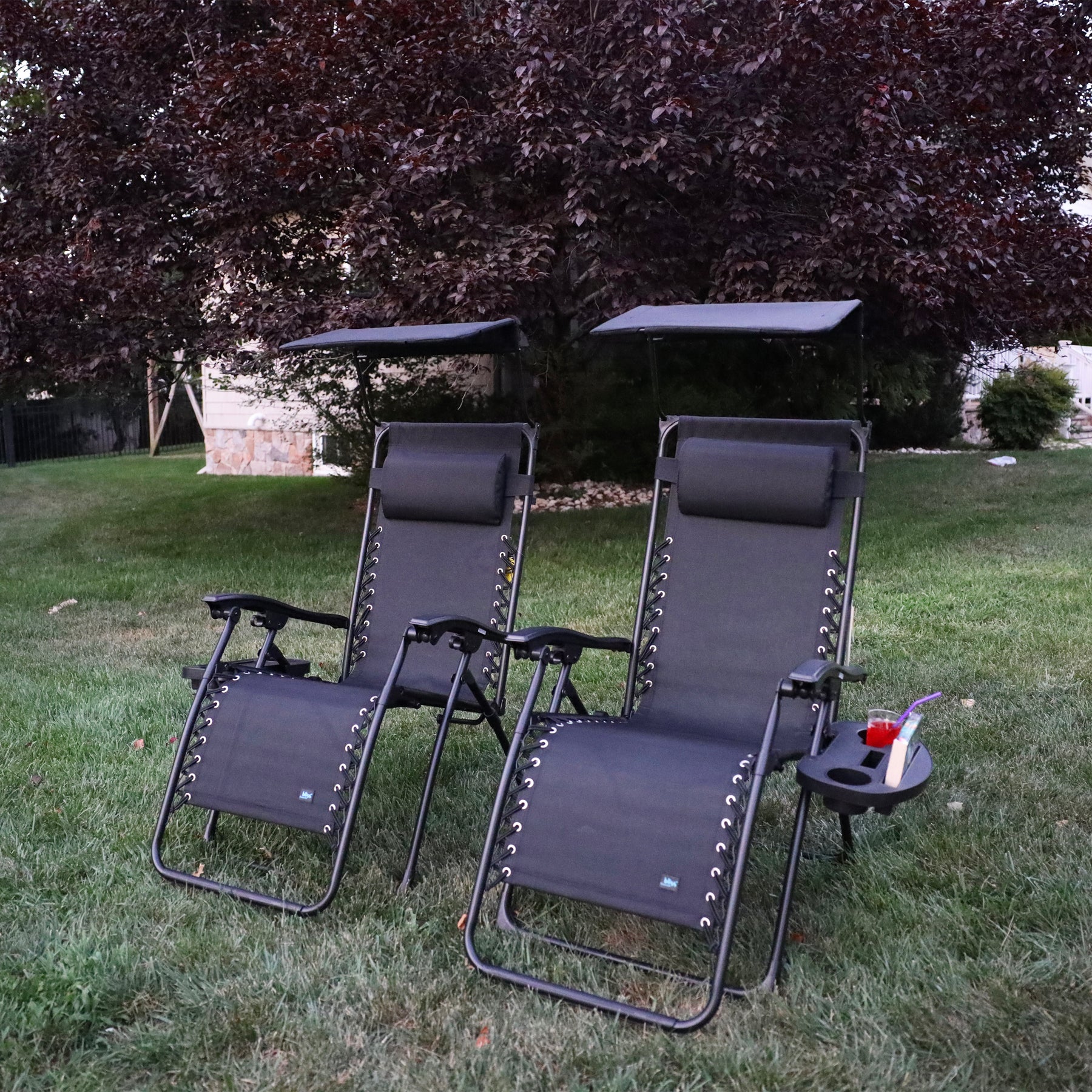 Set of 2 26-inch Black Zero Gravity Chairs on a lawn.