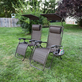 Set of 2 26-inch brown leaves Zero Gravity Chairs on a lawn.