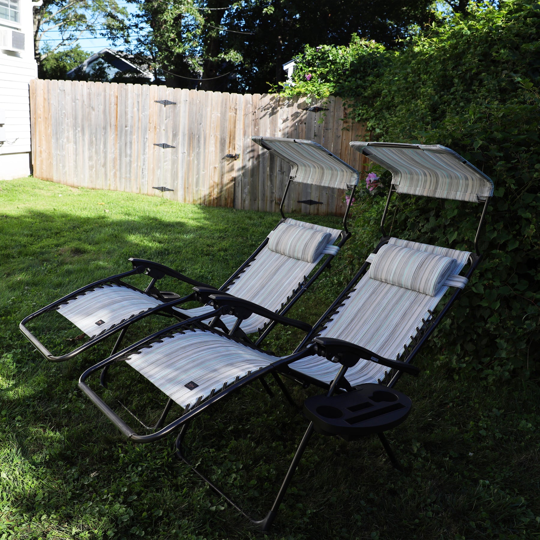 Set of 2 26-inch casual stripe Zero Gravity Chairs reclined on a lawn.