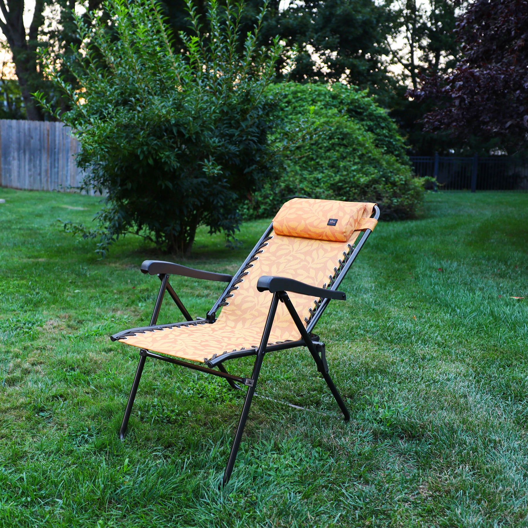 26-inch Reclining Amber Leaf Sling Chair on a lawn.