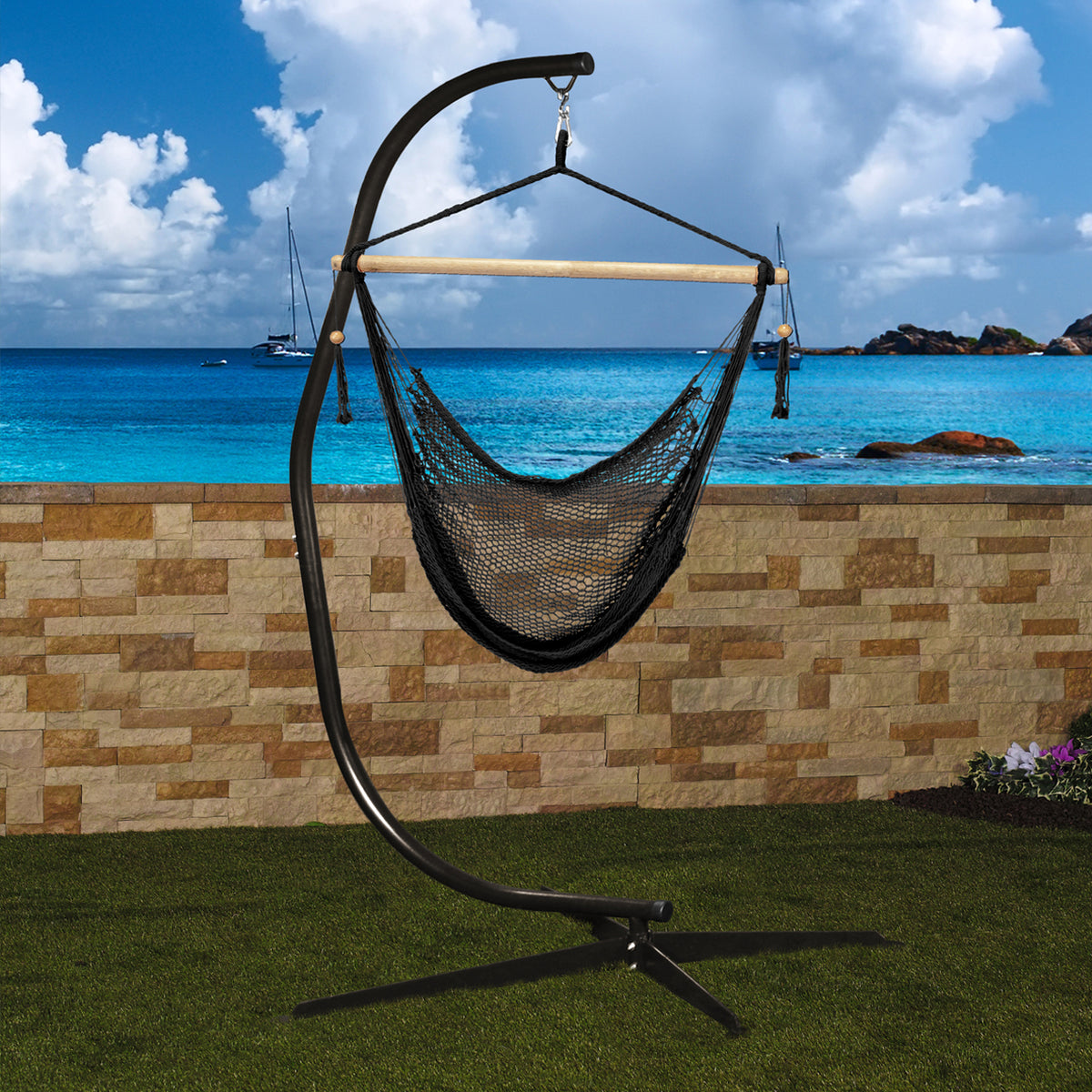 Bliss Hammocks 84-inch Swing Chair Stand with Hanging Hook holding a hammock chair outside with the ocean in the background.