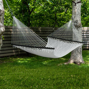 Bliss Hammocks 55-inch Wide 2-Person Weekender Deluxe Hammock with Spreader Bars hung outside between two trees.
