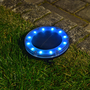 Bliss Outdoors Solar Powered Disc LED Pathway Light turned on and illuminating blue.