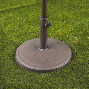 Bliss Outdoors Heavy-Duty Umbrella Base in the classic variation in grass with an umbrella inside.