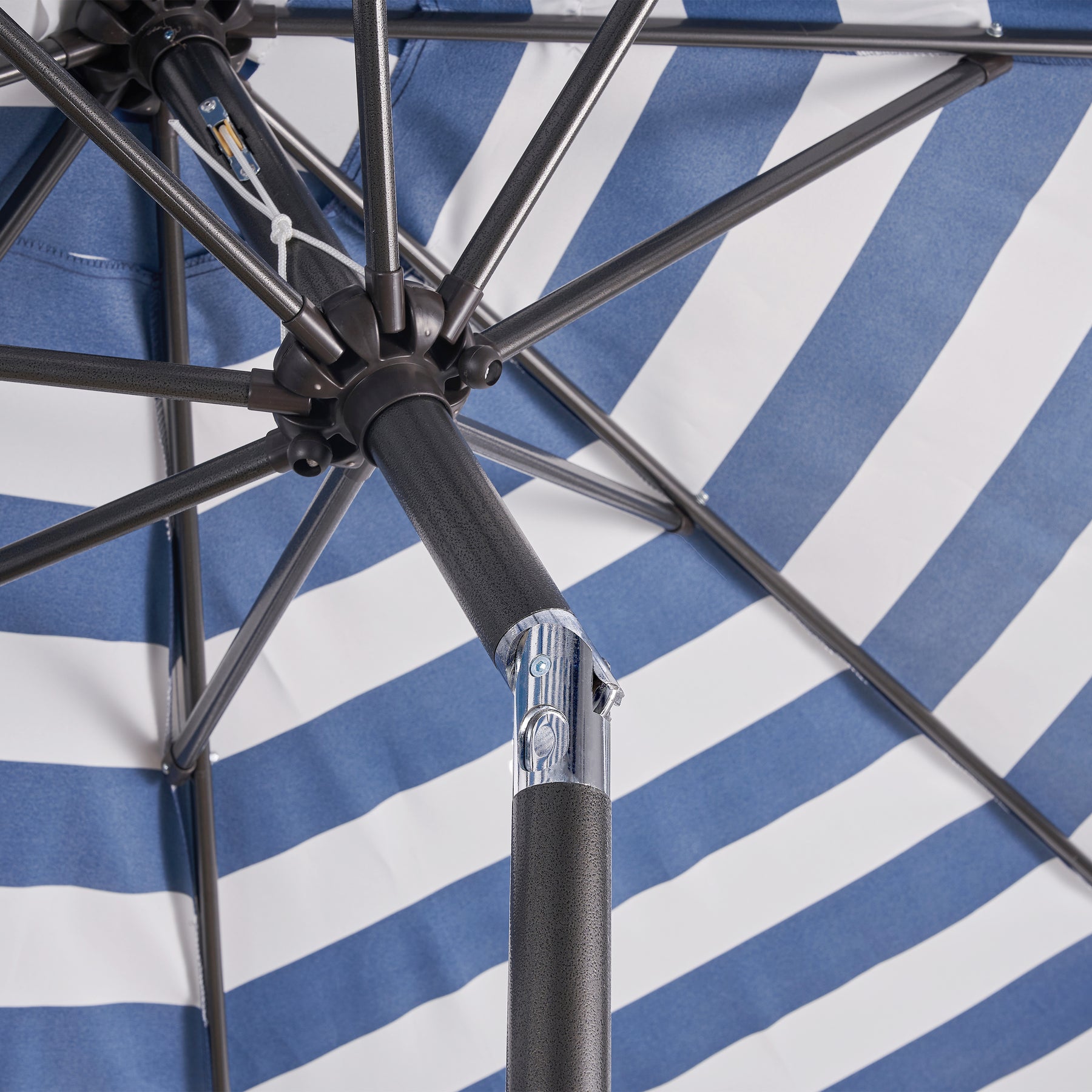 Close-up of the Push button tilt on the Bliss Outdoors 9-foot Patio Umbrella with Aluminum Pole.